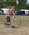 JG riding a penny farthing 
